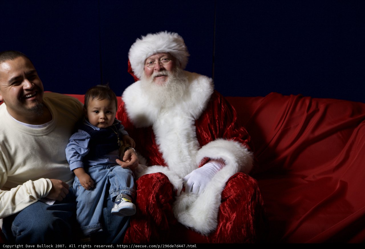 Santa Claus visits a family during their Christmas party