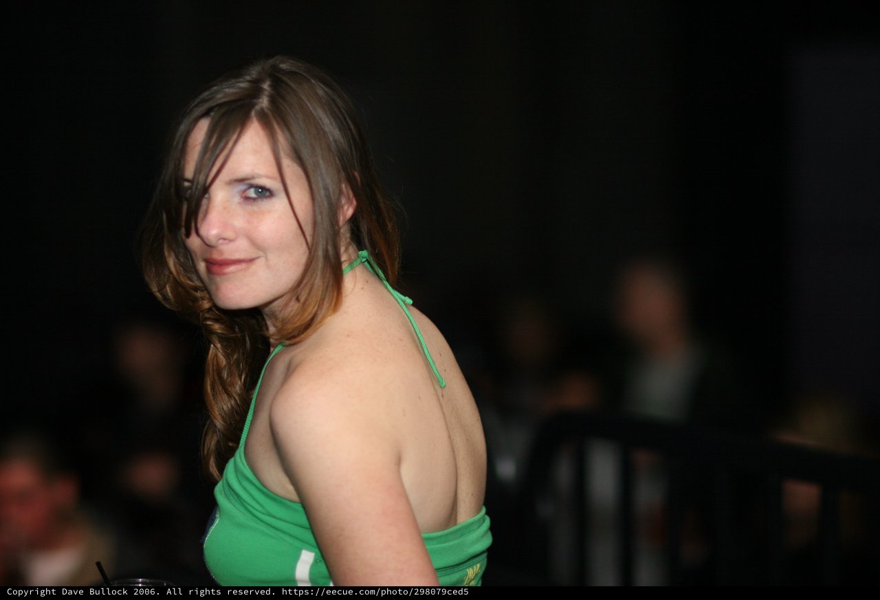 Woman in Green Halter Top Glances Back Playfully