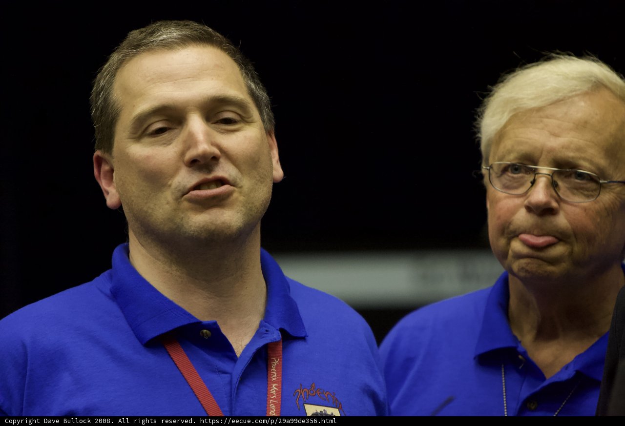 Two Men with Blue Shirts and Glasses