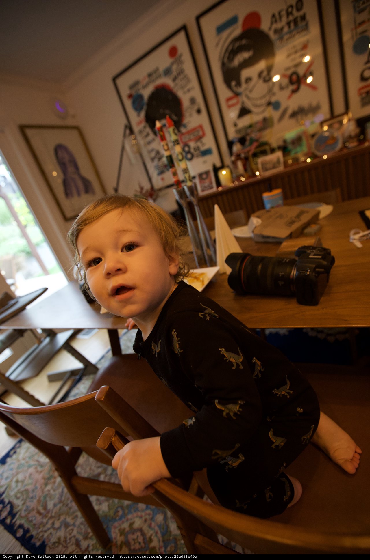 Toddler in Dinosaur Pajamas at Creative Home Office