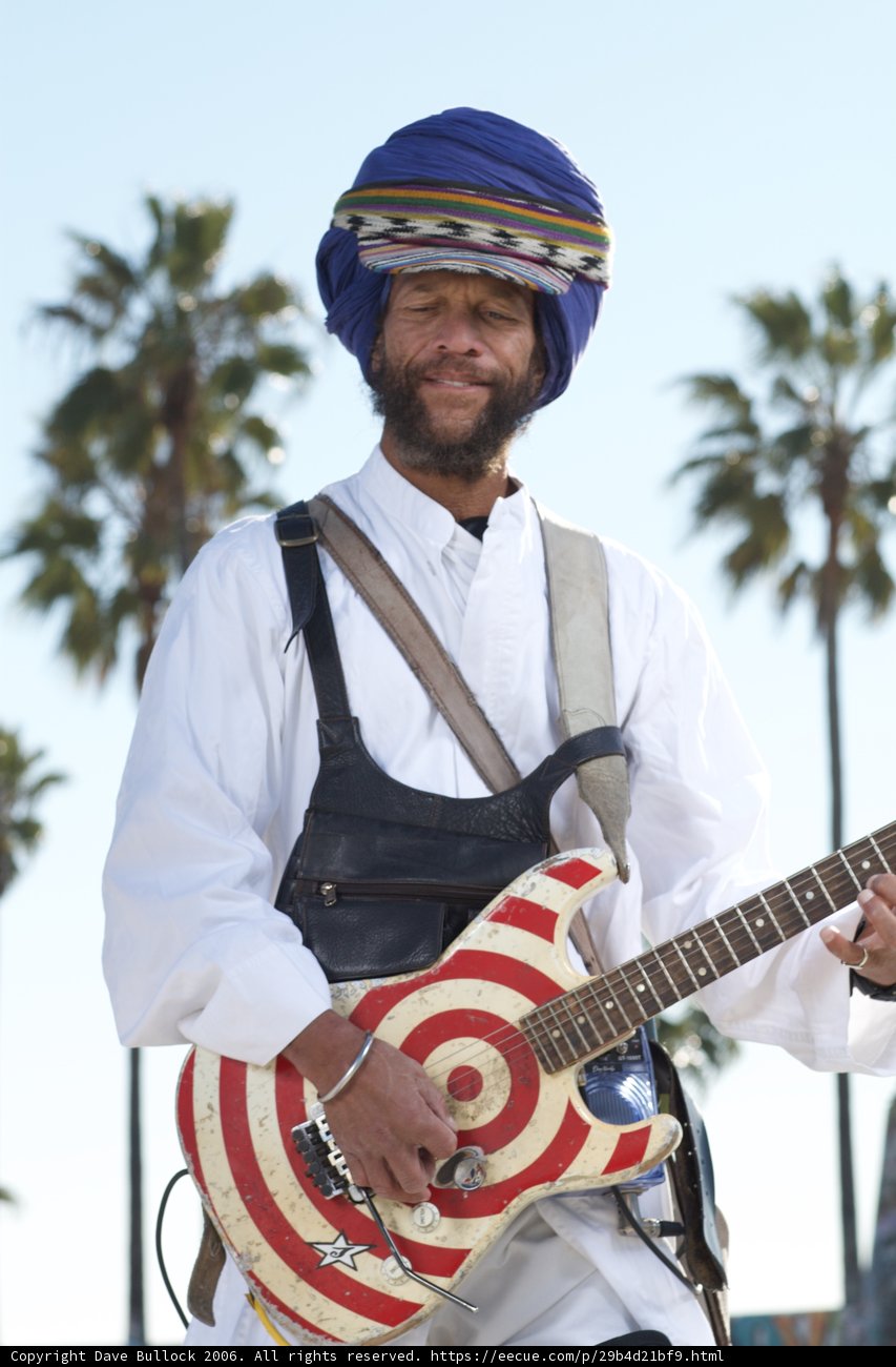 Man with a Turban Strumming His Guitar in Nature
