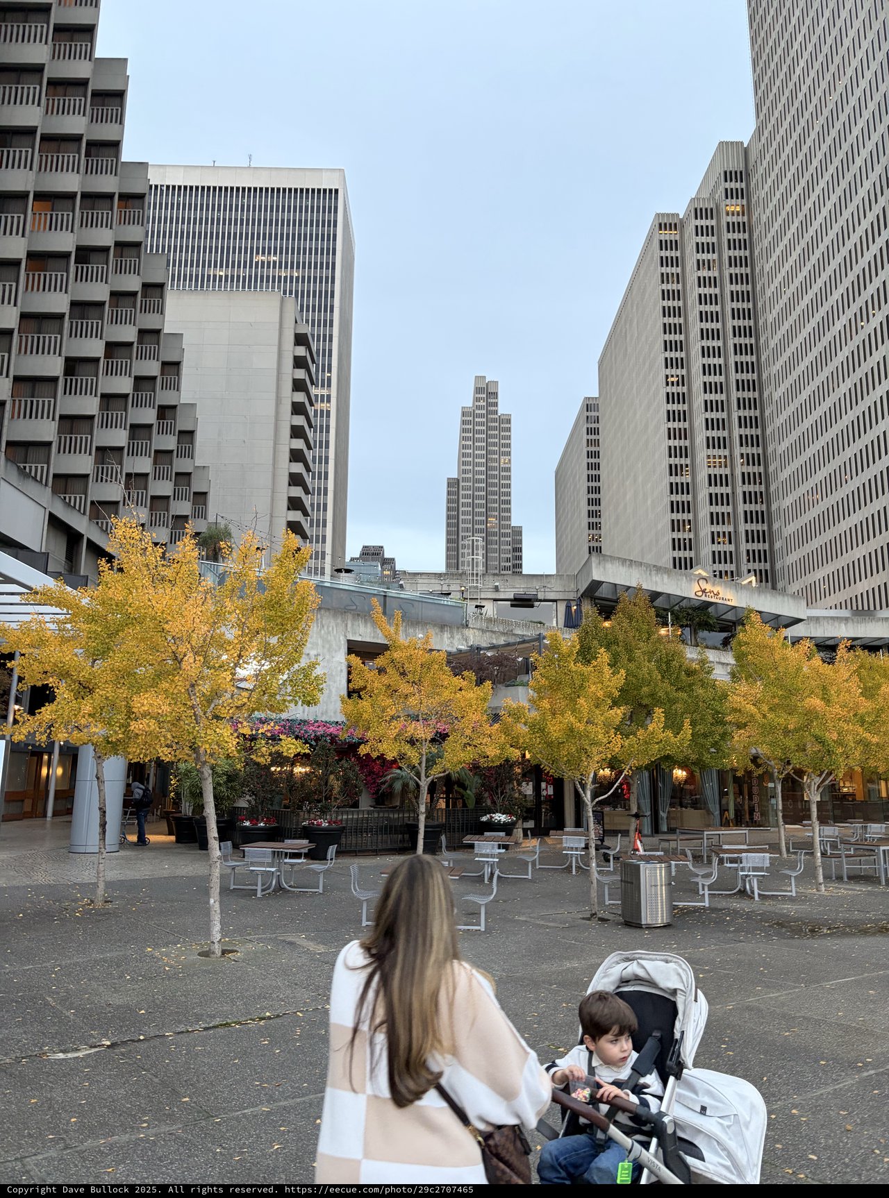 Mother and Child in Modern Urban Plaza