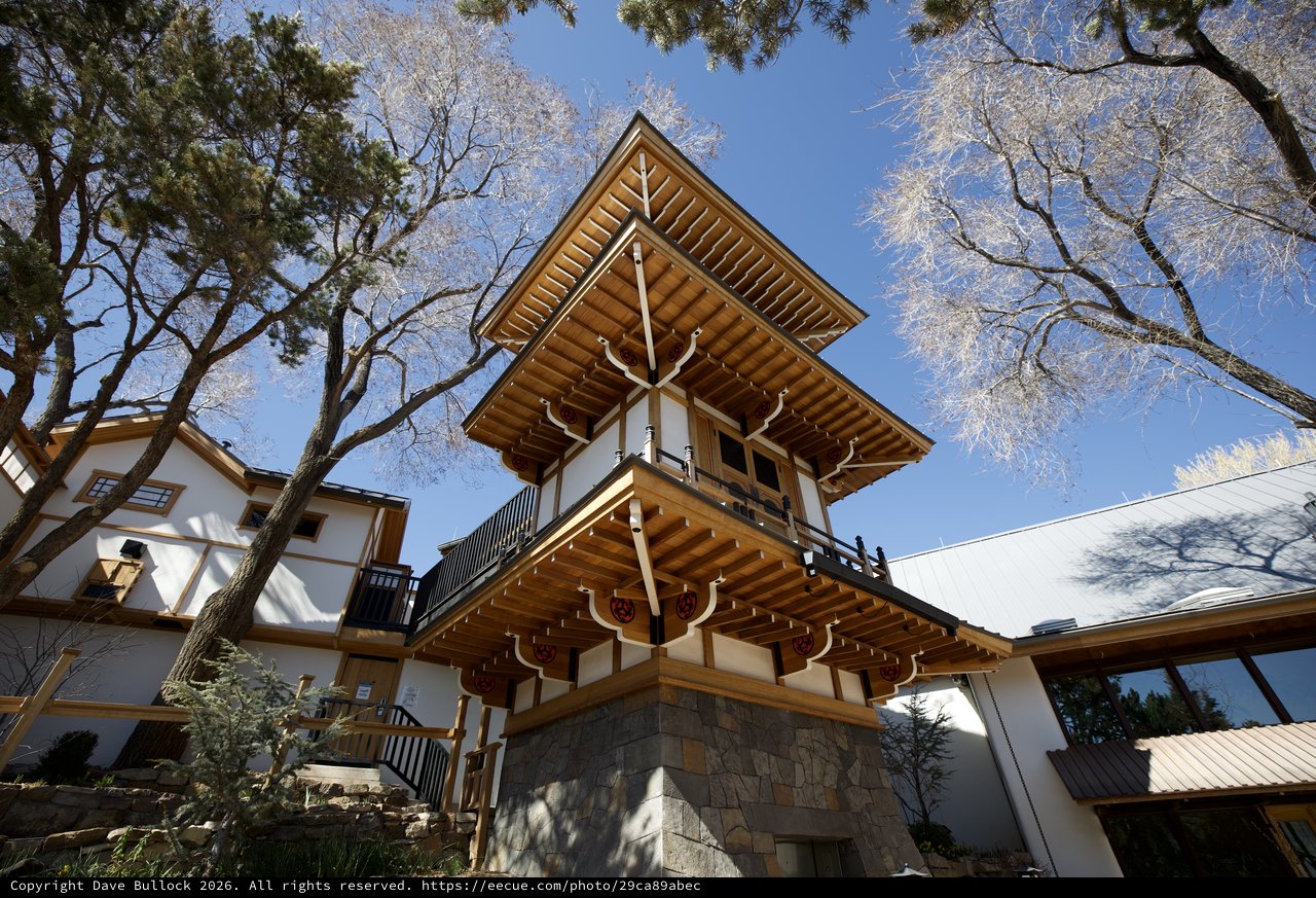 Traditional Japanese Bell Tower Among Frost-Covered Trees