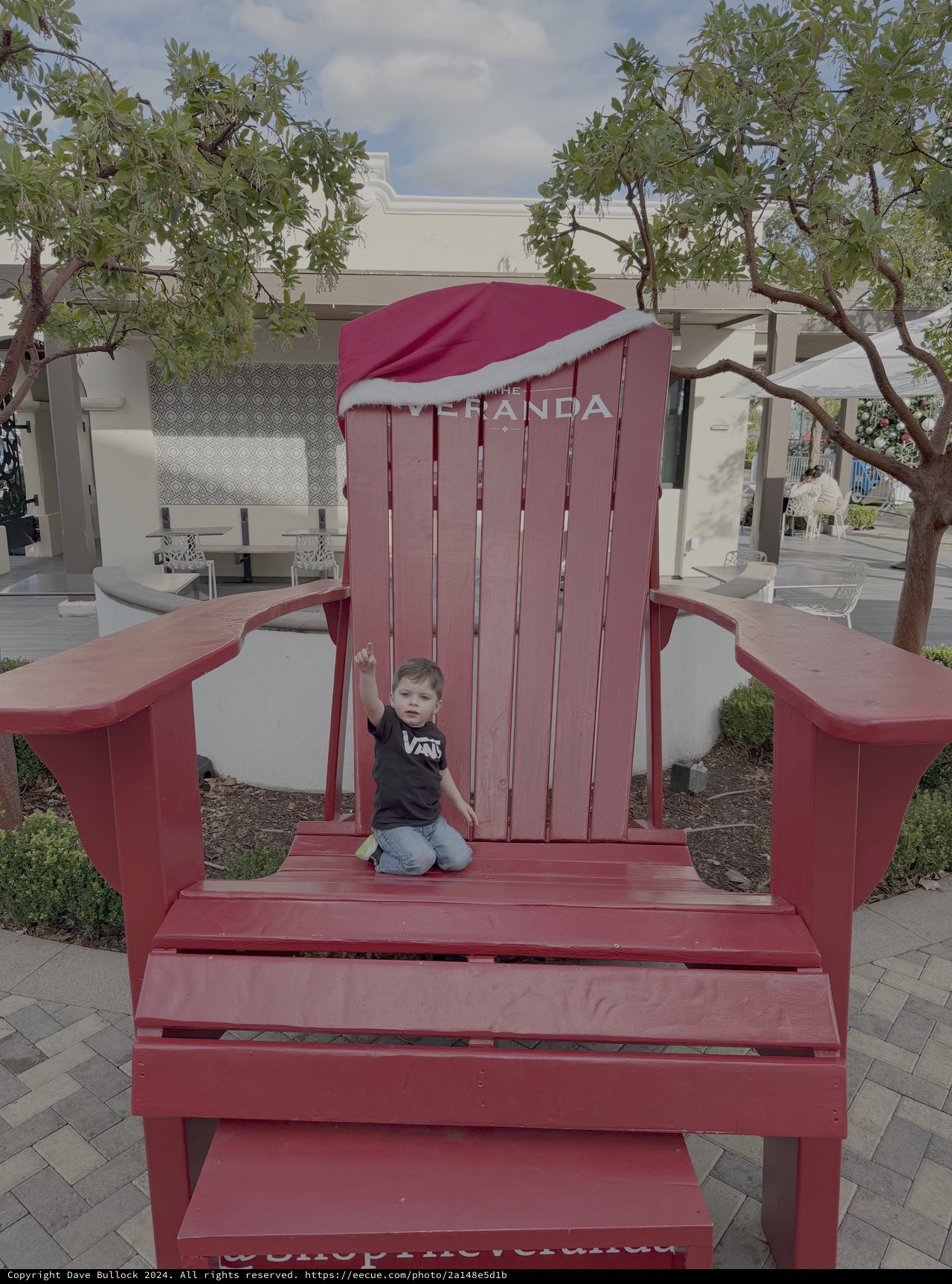 Child Playing in Giant Red Adirondack Chair