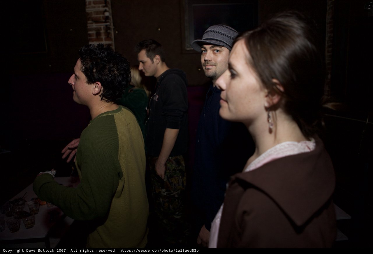 Candid Moments at a Dimly Lit Indoor Gathering