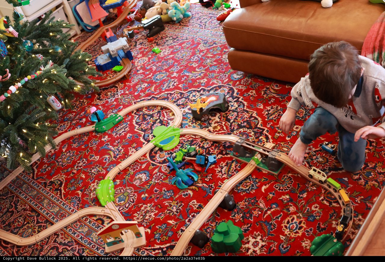Child Playing with Wooden Train Set on Christmas