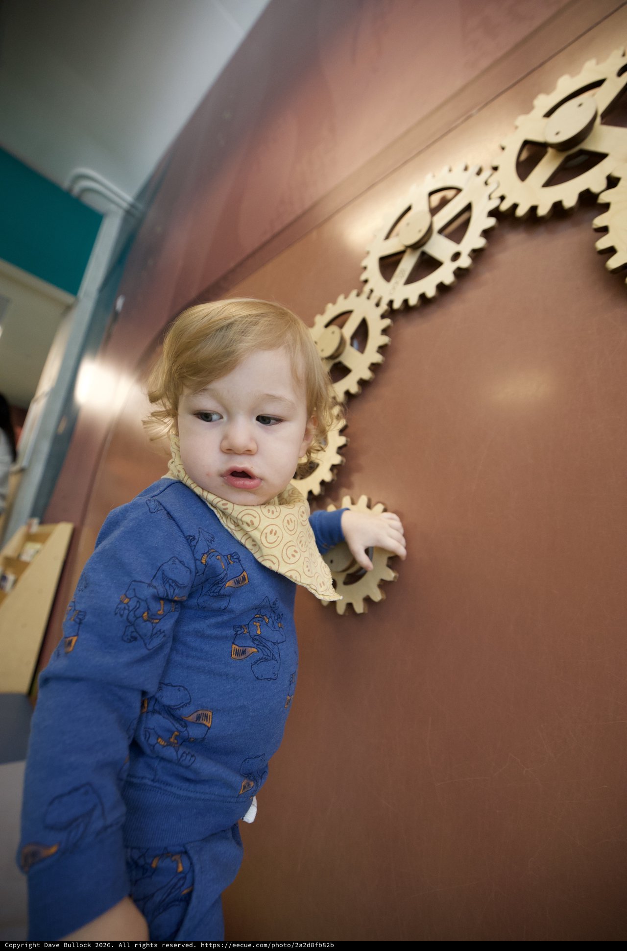 Curious Toddler Explores Interactive Gear Wall Display