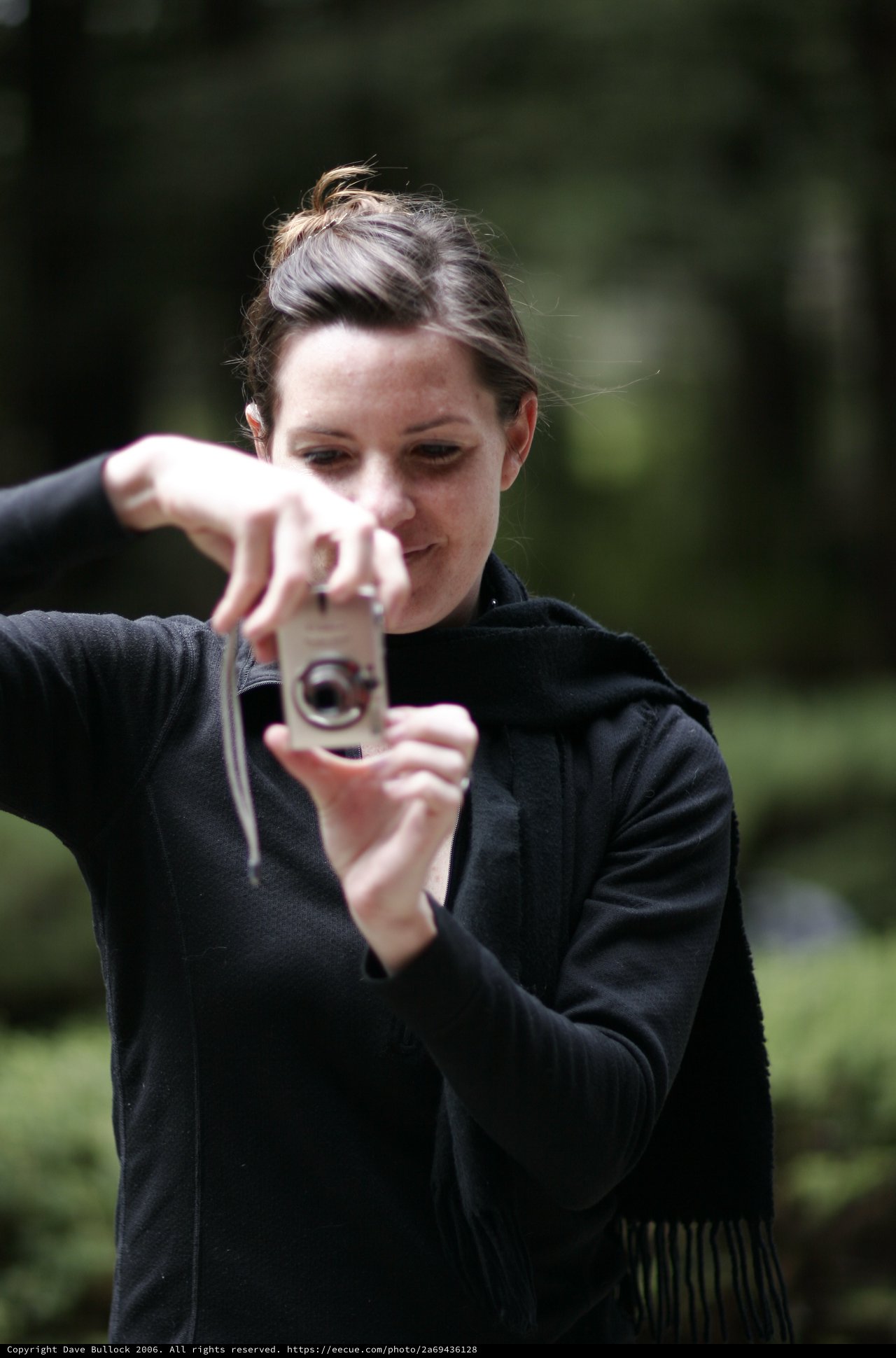 Photographer Captures Moment with Compact Camera Outdoors