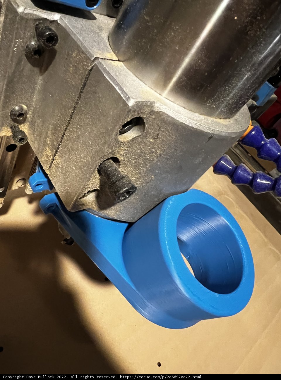 Metal Bracket Clamped to Blue Pipe