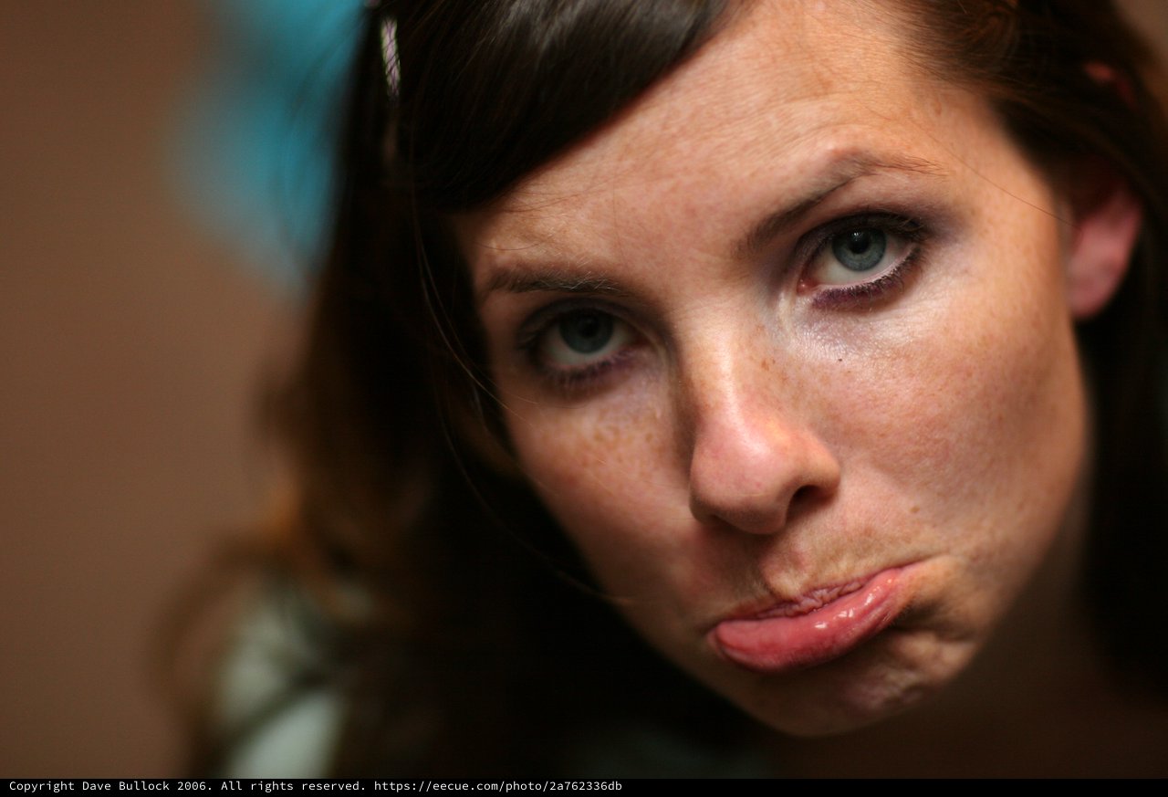 Pouty Blue-Eyed Woman With Freckles Close-Up