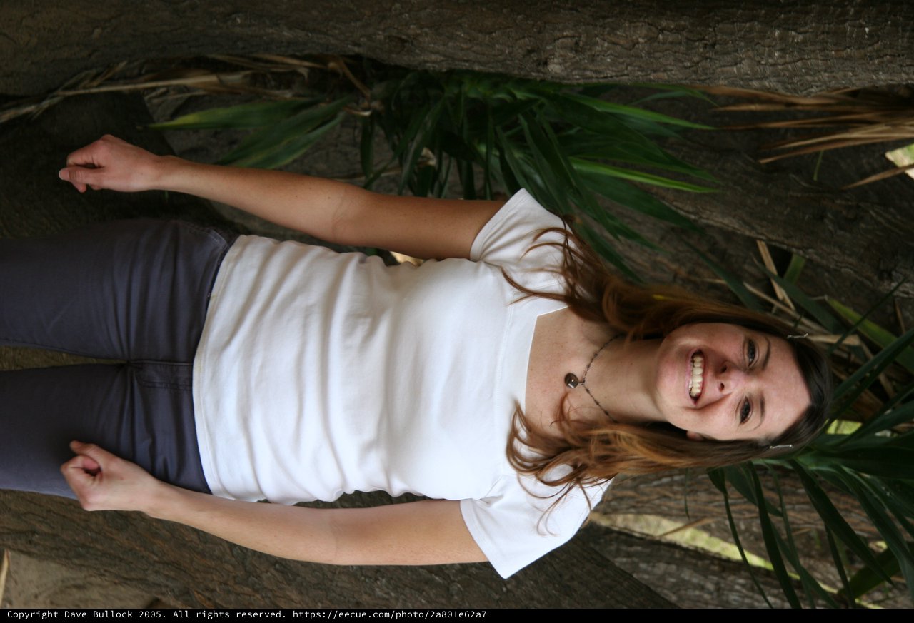 Smiling Woman Posing Among Tropical Trees Outdoors