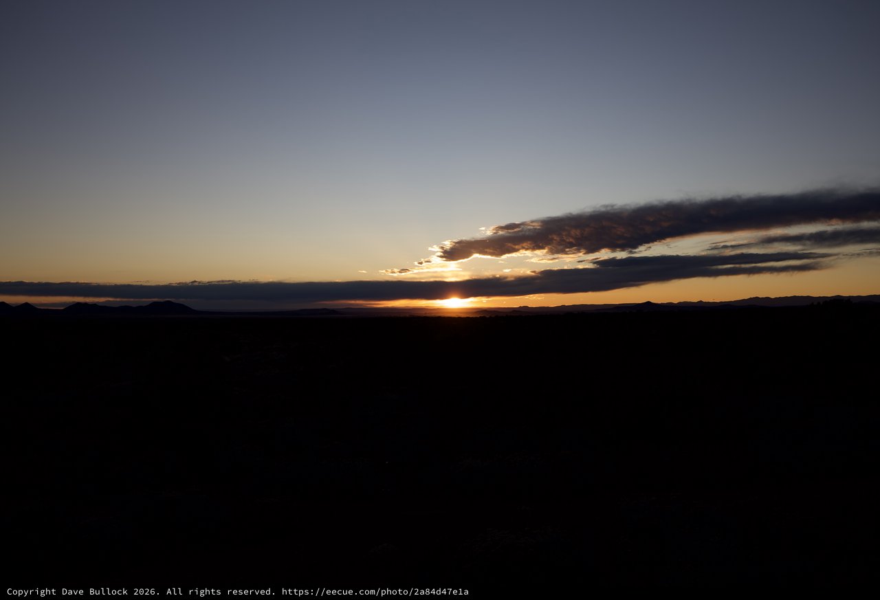 Dramatic Sunset Over Desert Mountains and Plains