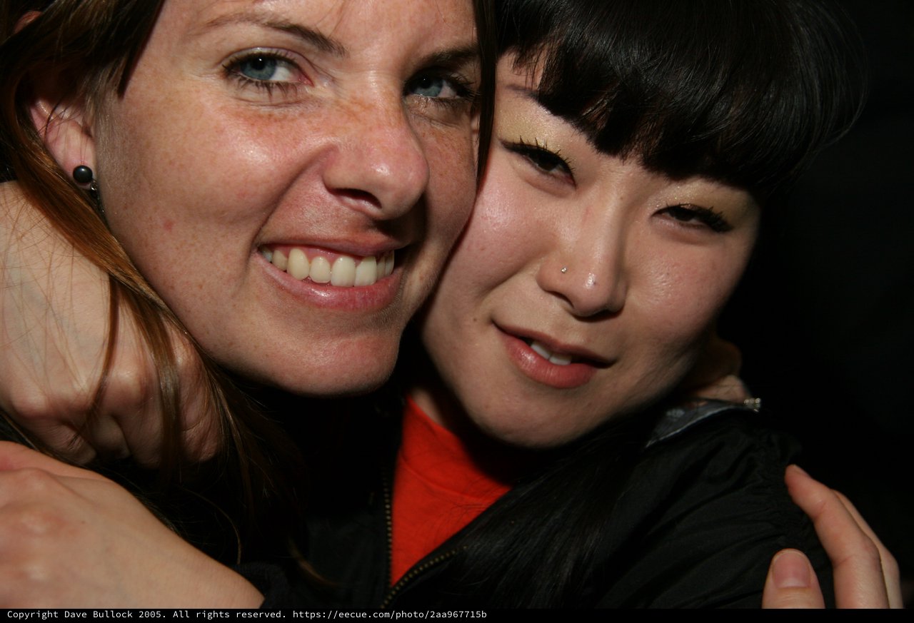 Two Friends Share a Warm Embrace at Night