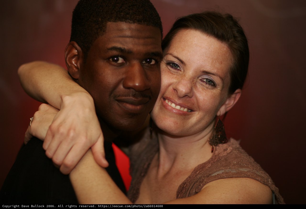 Warm Embrace: Couple Poses Together at Evening Event