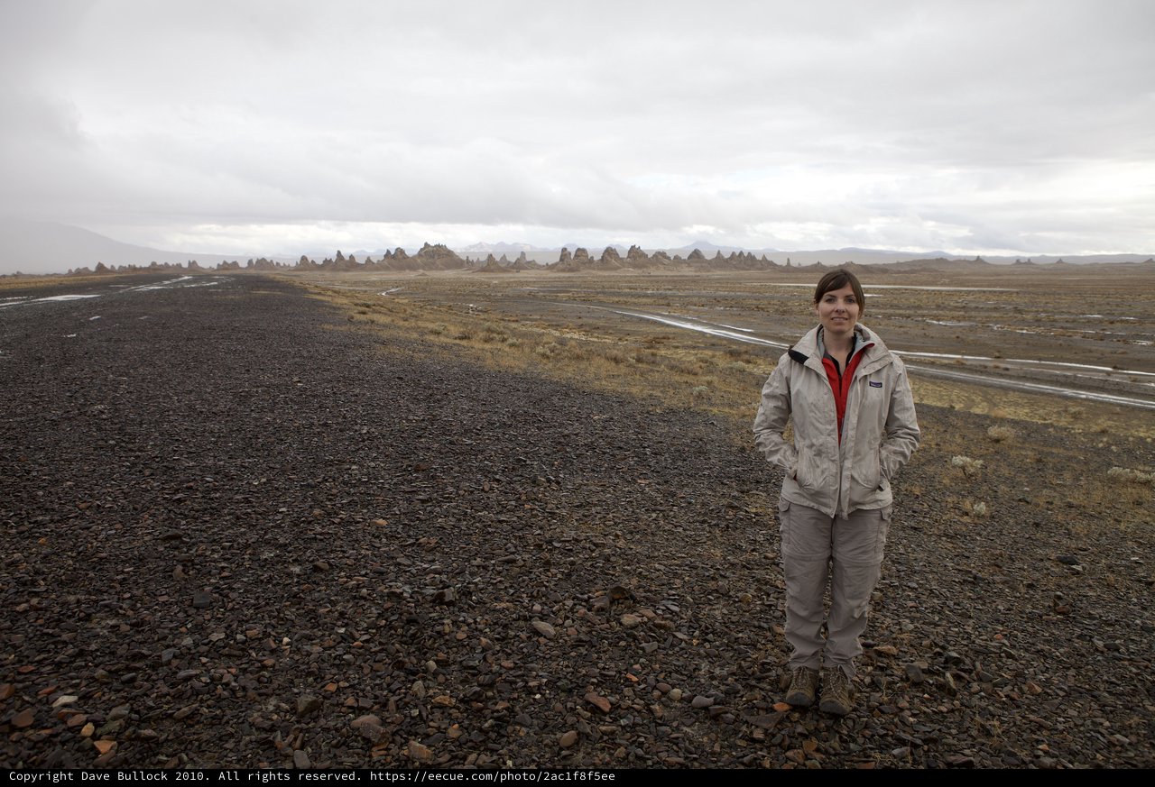 Woman Standing Among Ancient Tufa Spires in Desert