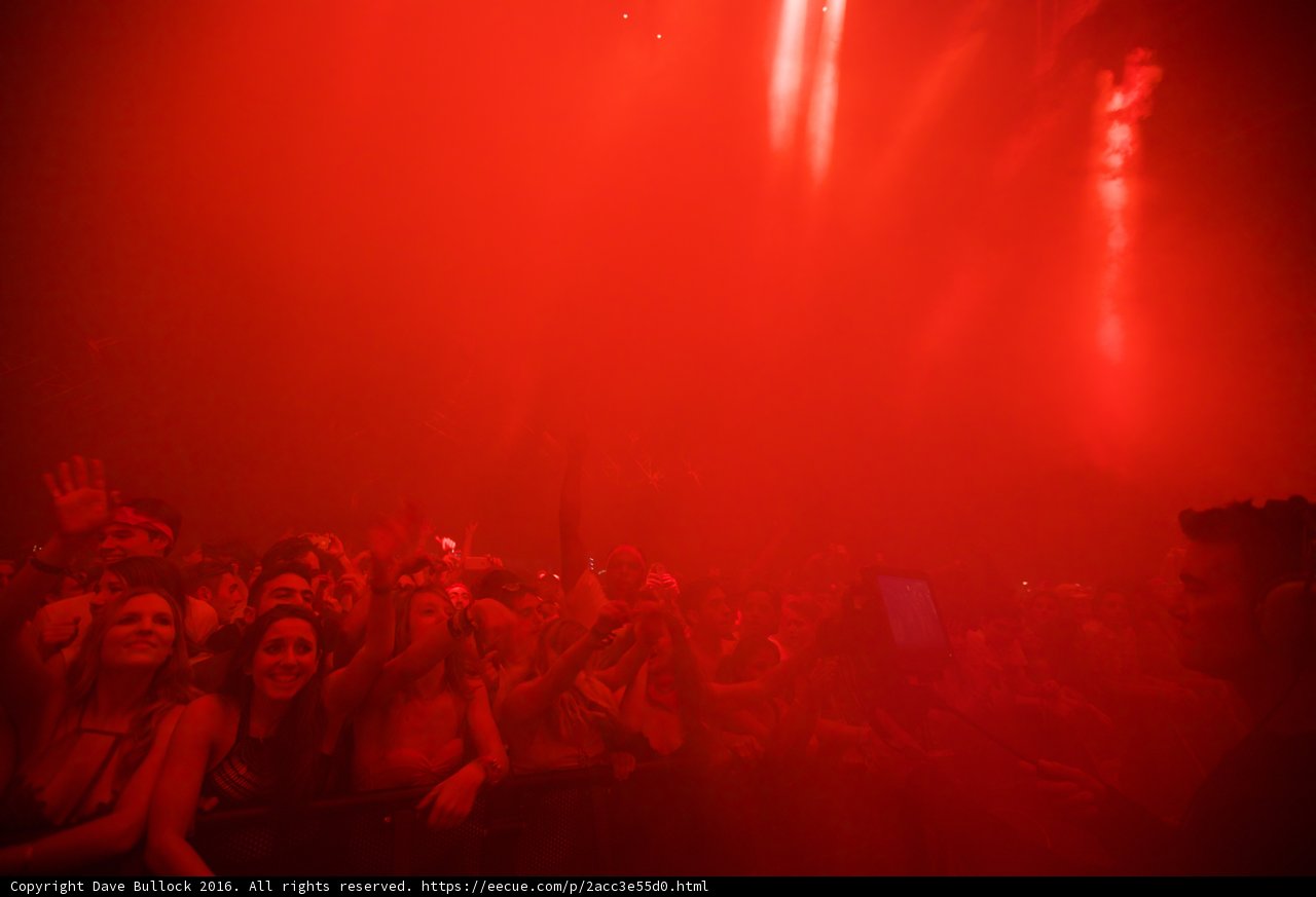 Red Spotlight on a Vibrant Concert Crowd