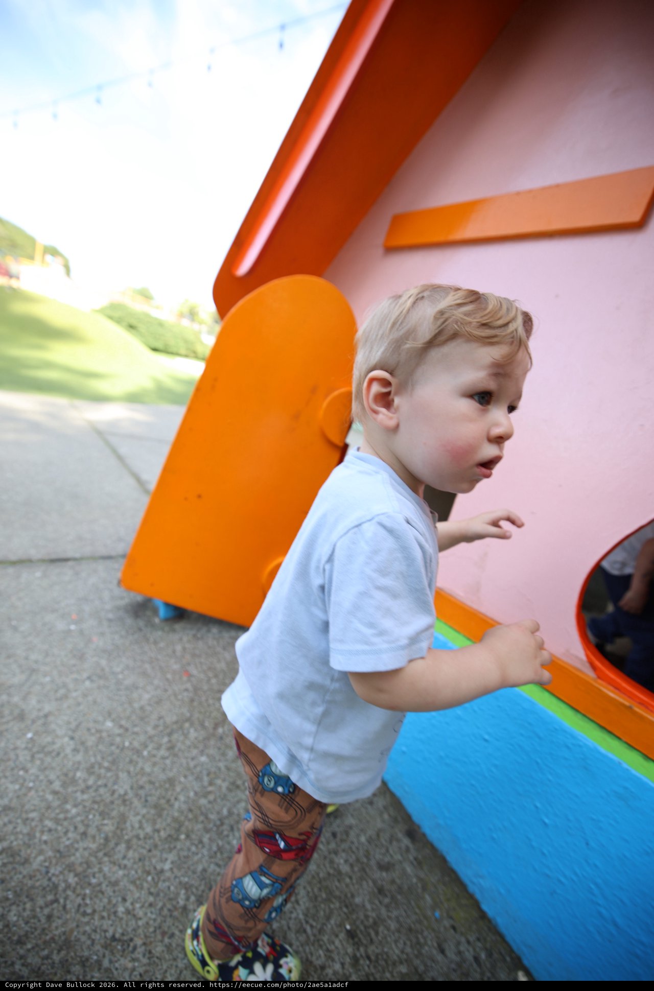 Young Child Playing at Colorful Playground Structure