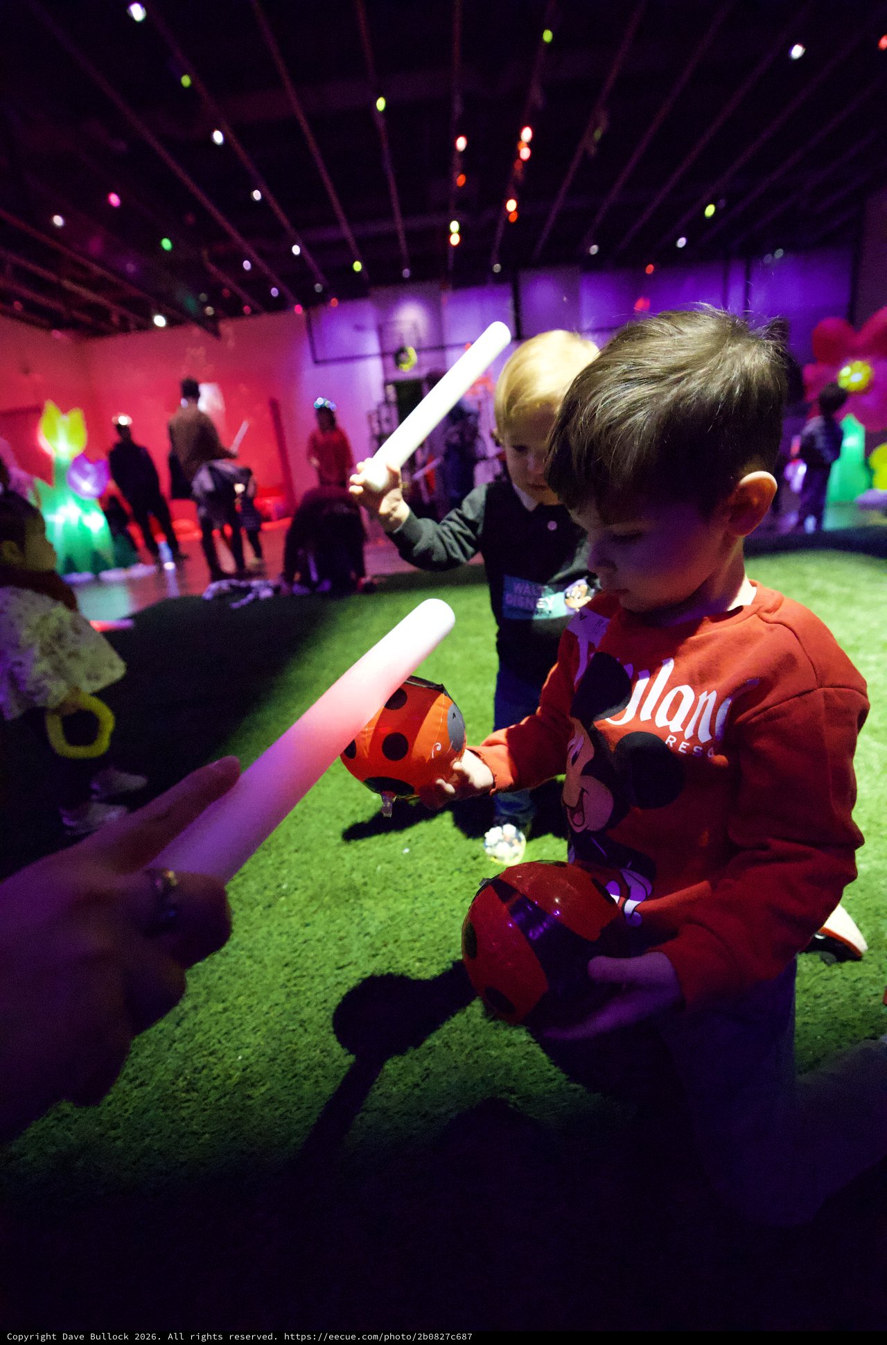 Children Playing with Glow Sticks at Baby Rave Event