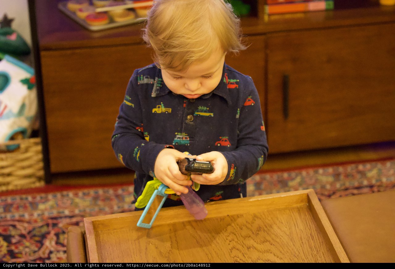 Toddler Playing with Toy Cars on Wooden Tray