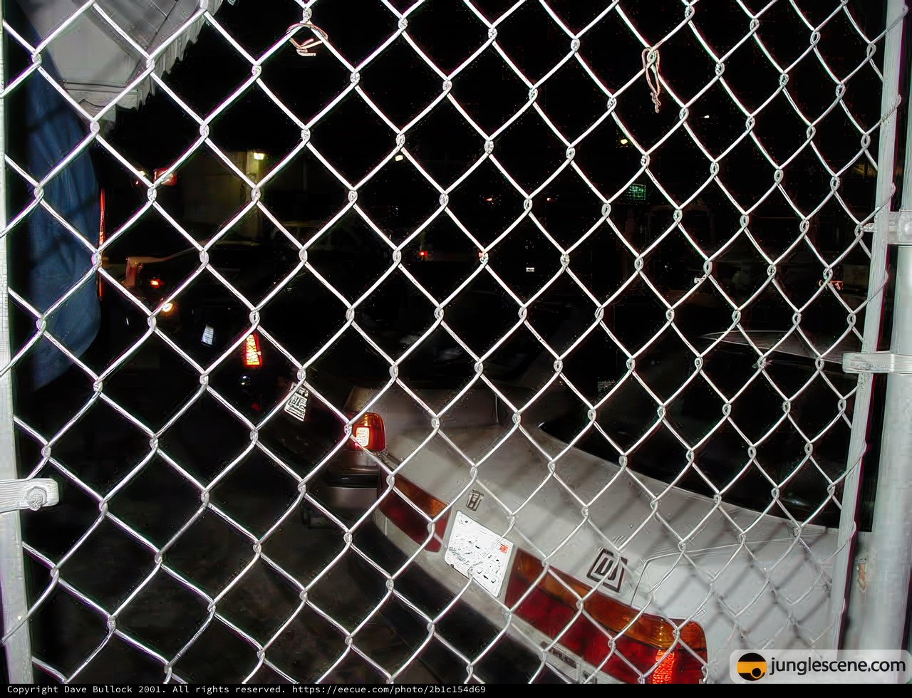 Parked Car and Chain Link Fence
