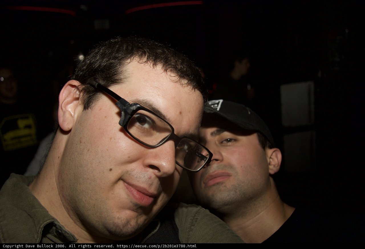 Two Glasses-Wearing Men Taking a Selfie at a Party