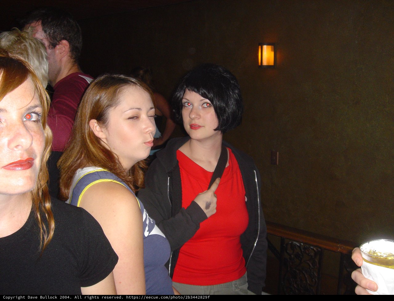 Three Friends Posing at a Dimly Lit Bar