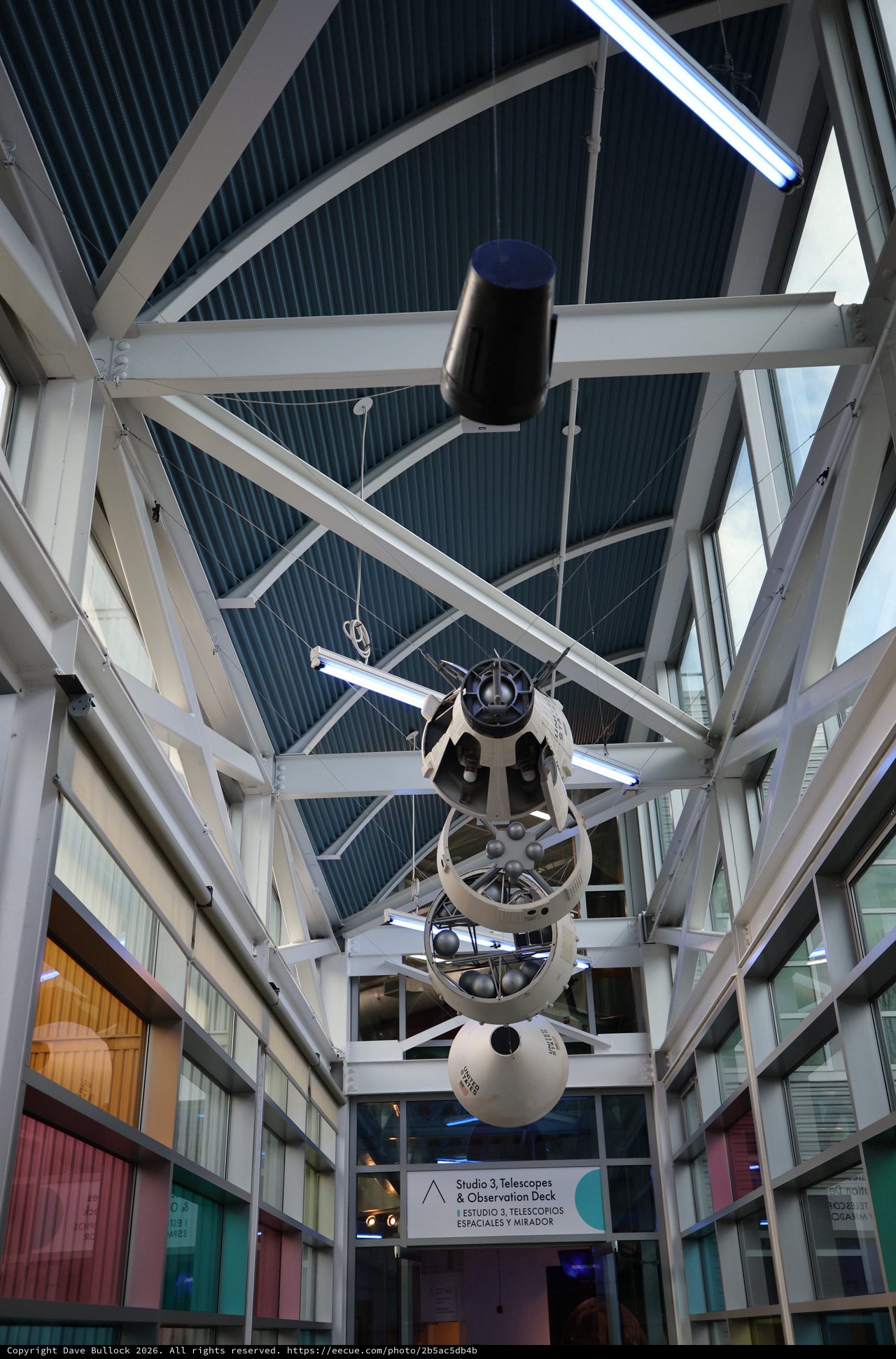 Vintage Space Telescope Suspended in Modern Observatory Atrium