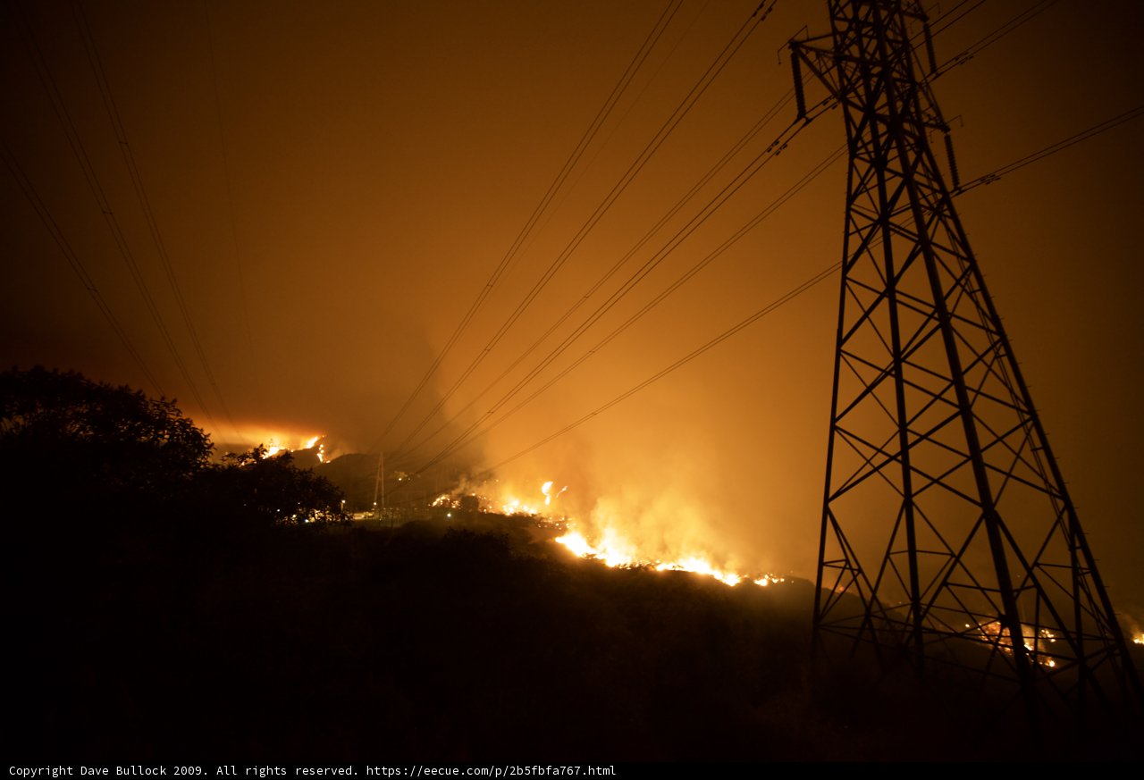 Flames Threaten Power Lines on Hillside