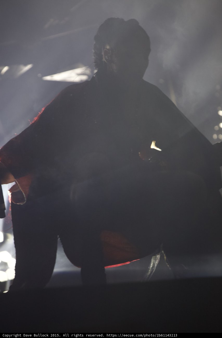 FKA twigs Dramatic Backlit Silhouette Behind Braided Ponytail Red Brocade Kimono Baby Hairs Theatrical