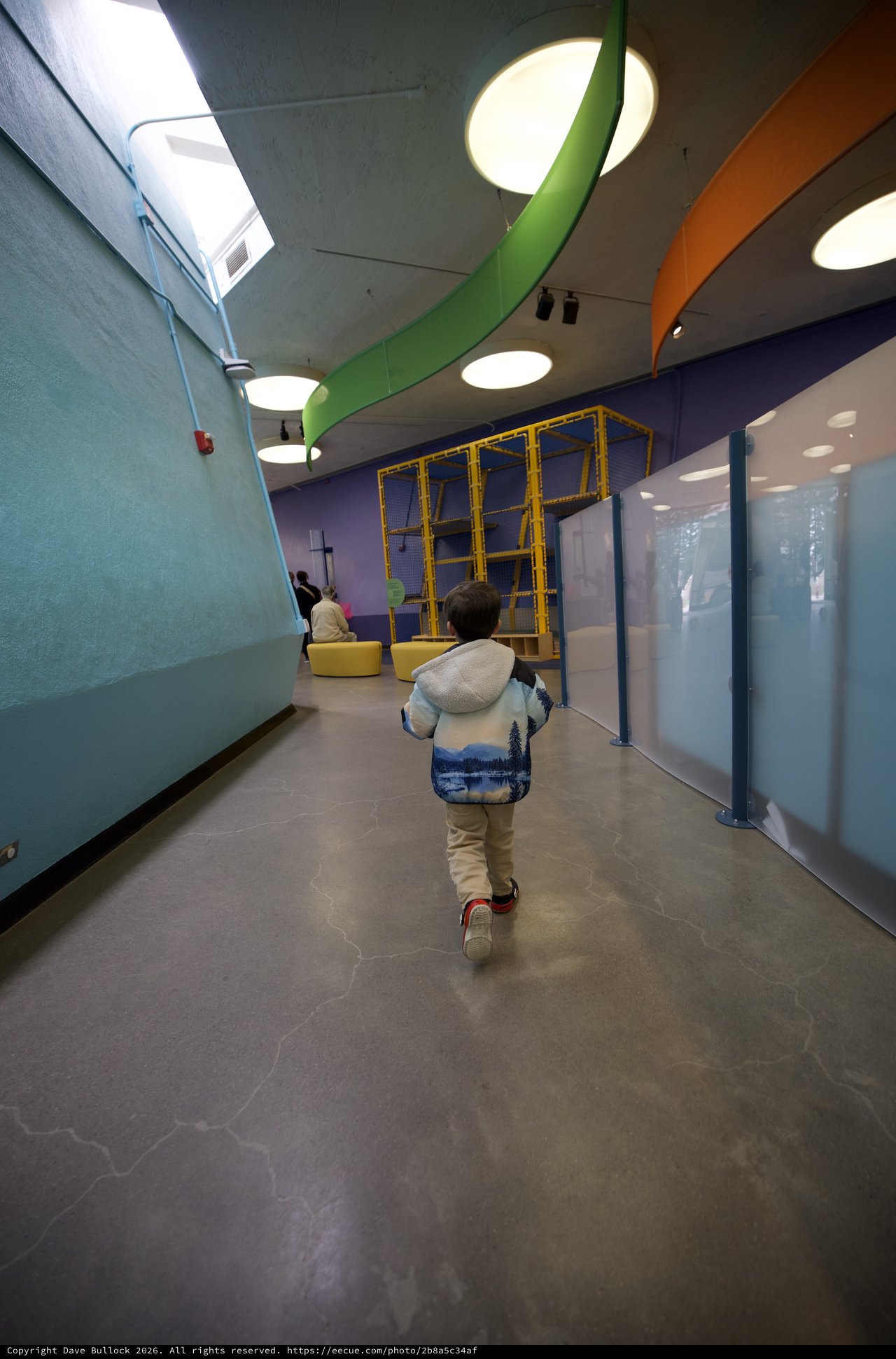 Child Exploring Colorful Modern Play Space Corridor