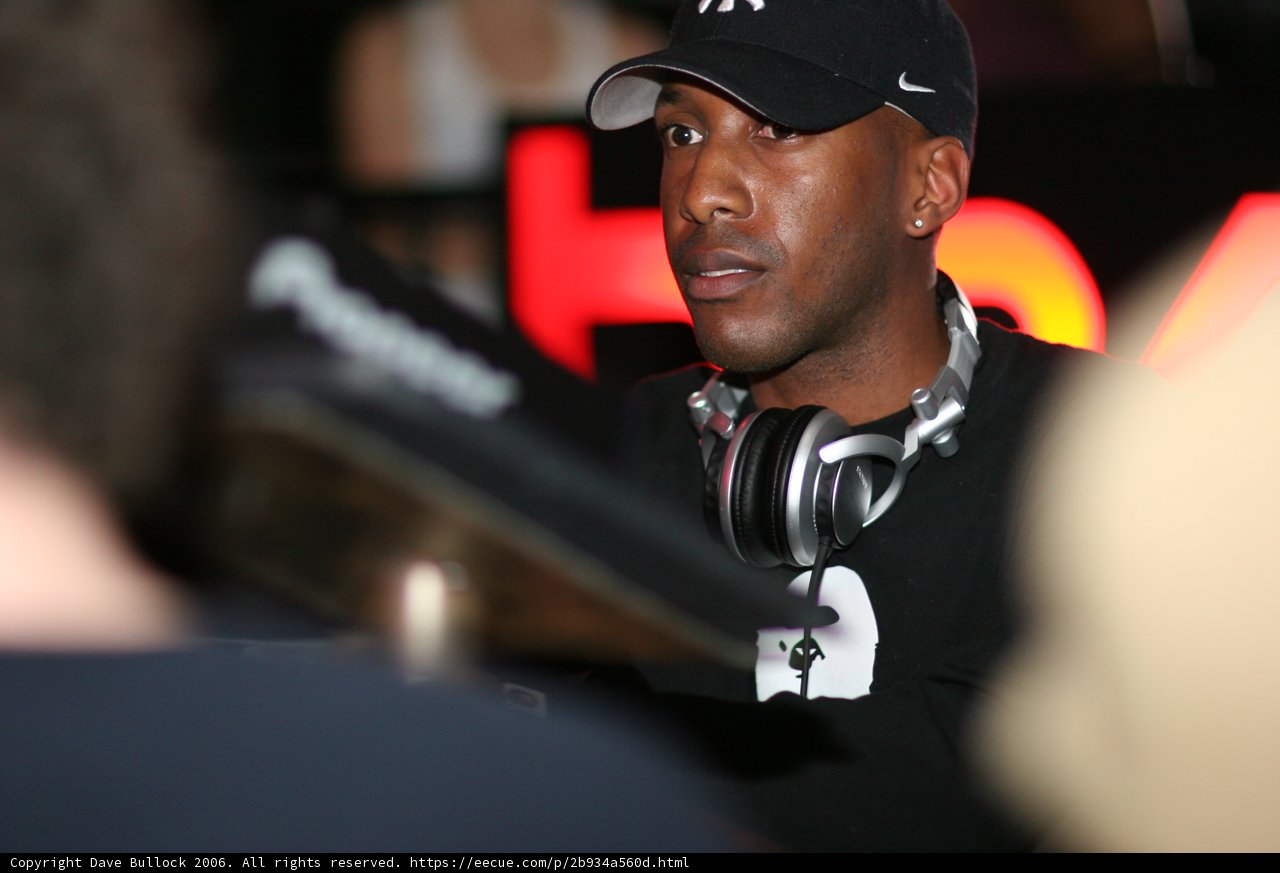Black Shirted Man Rocks The Cap And Headphones