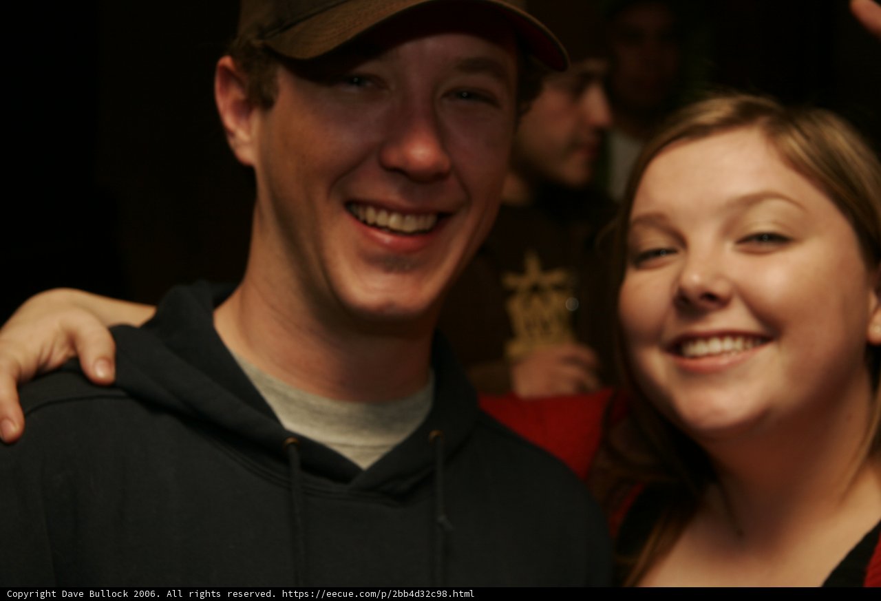 Smiling Couple Sporting Baseball Caps
