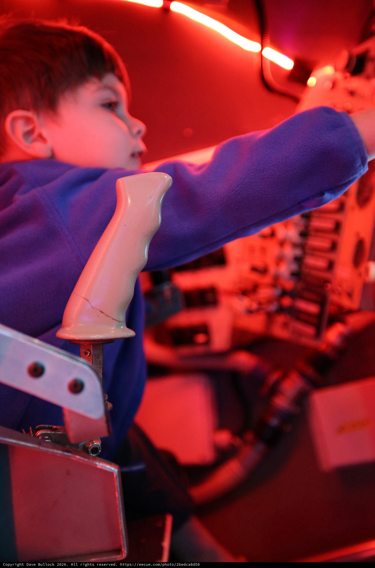 Child Interacting with Robotic Arm at Science Center