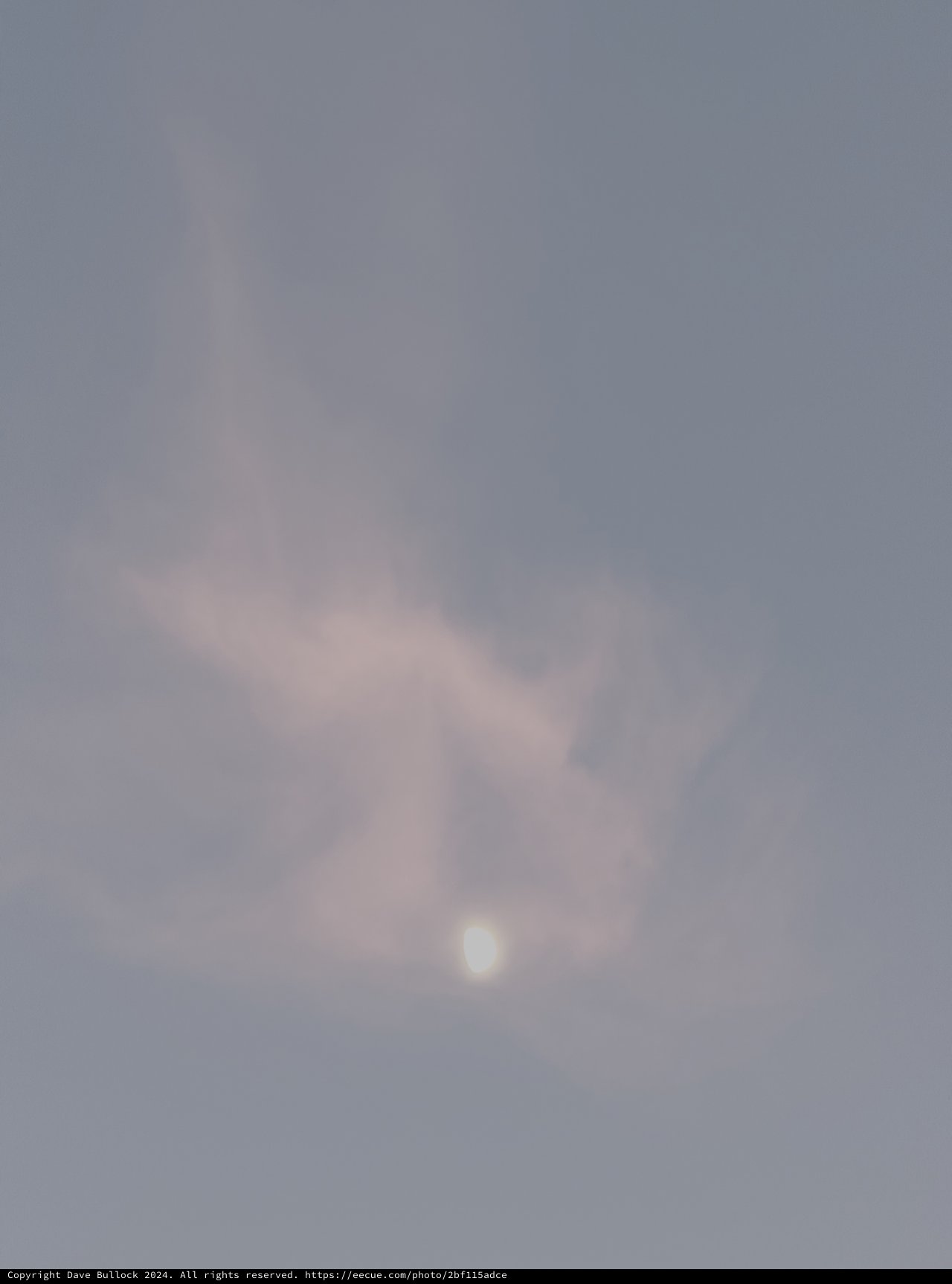 Misty Moon Through Atmospheric Clouds