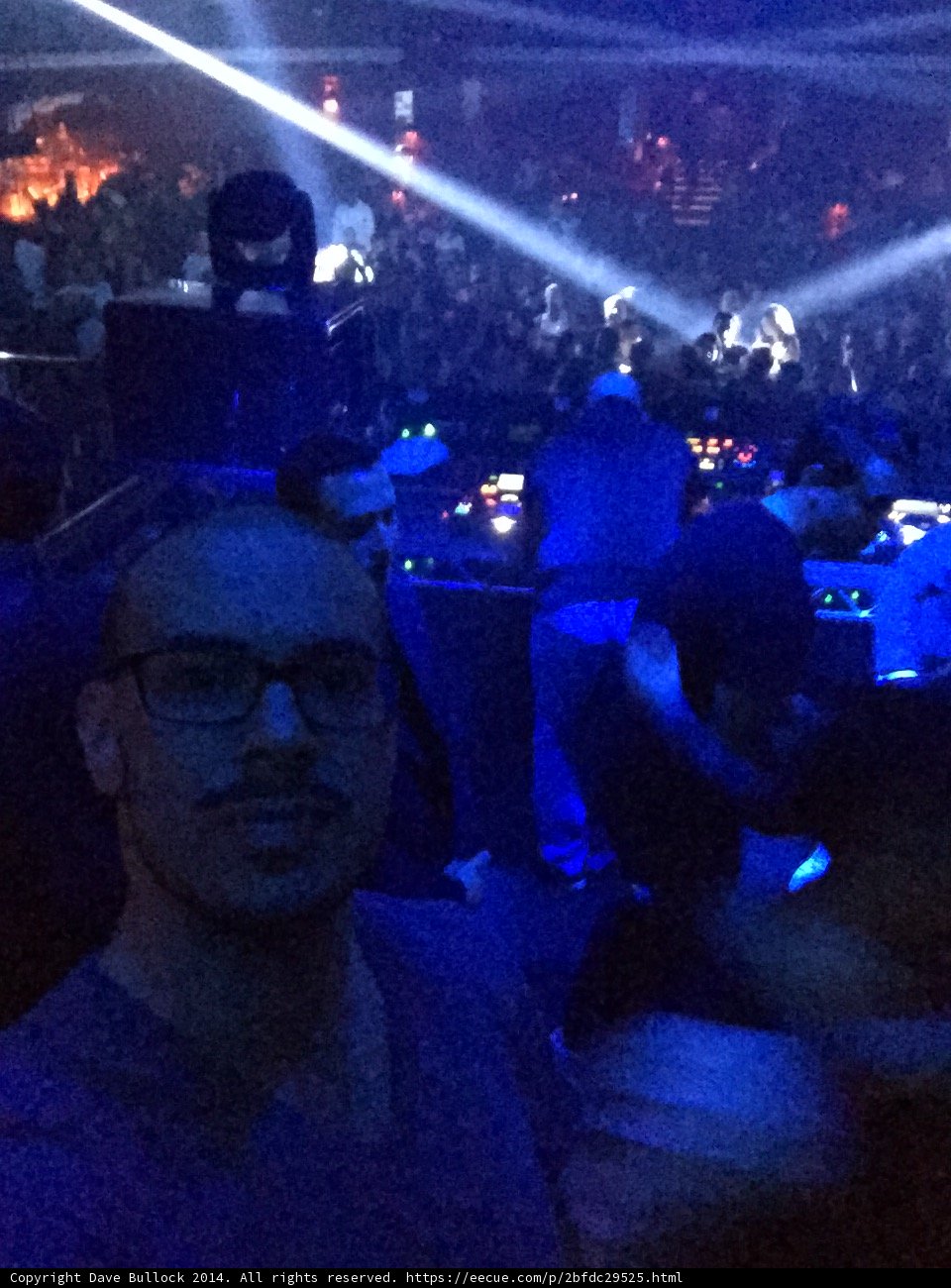 Man with Glasses Stands Out in Nightclub Crowd