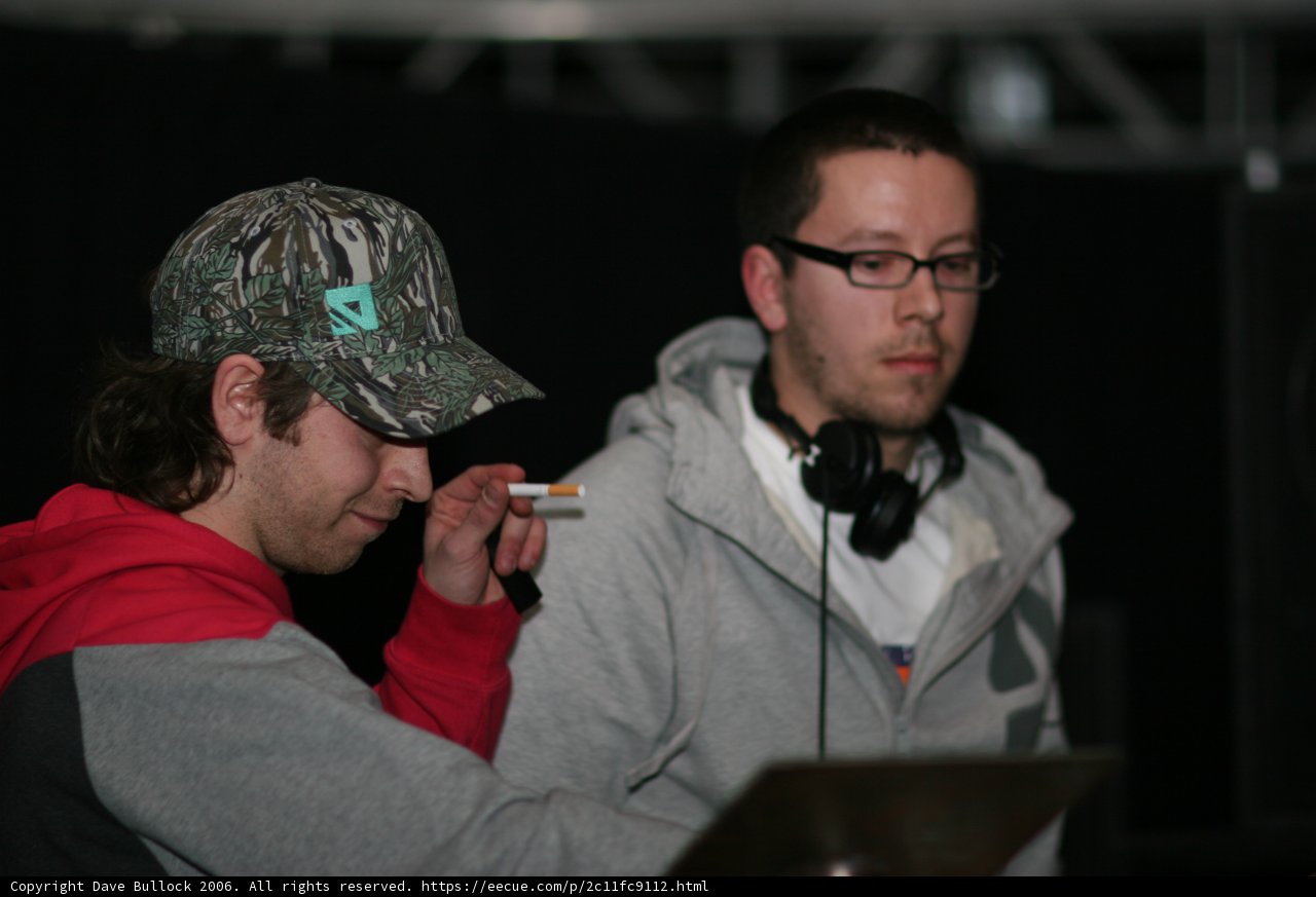 Two Men Sporting Caps and Glasses