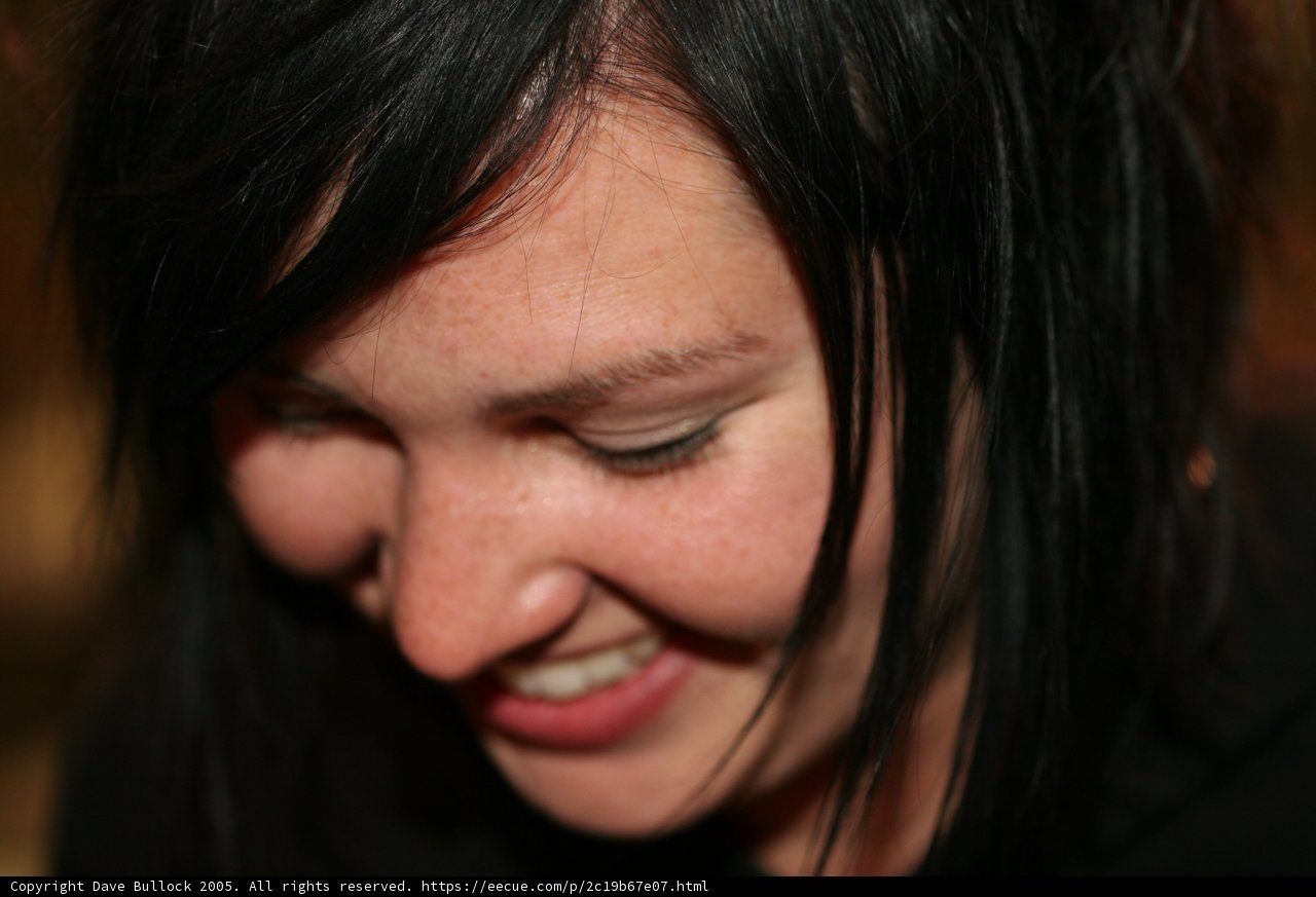 Black-Haired Woman Beaming with Joy