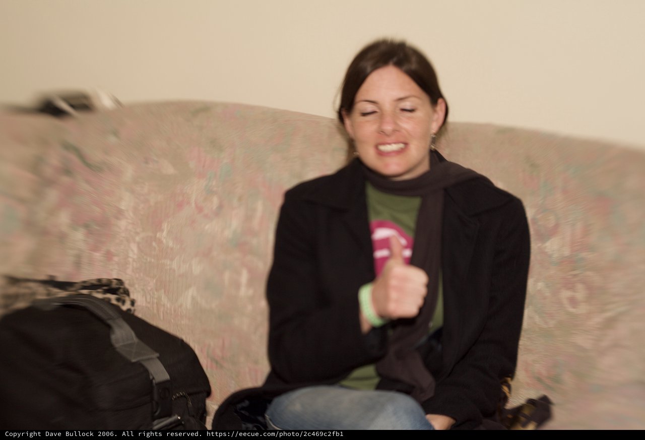 Woman Laughing Joyfully on Floral Sofa