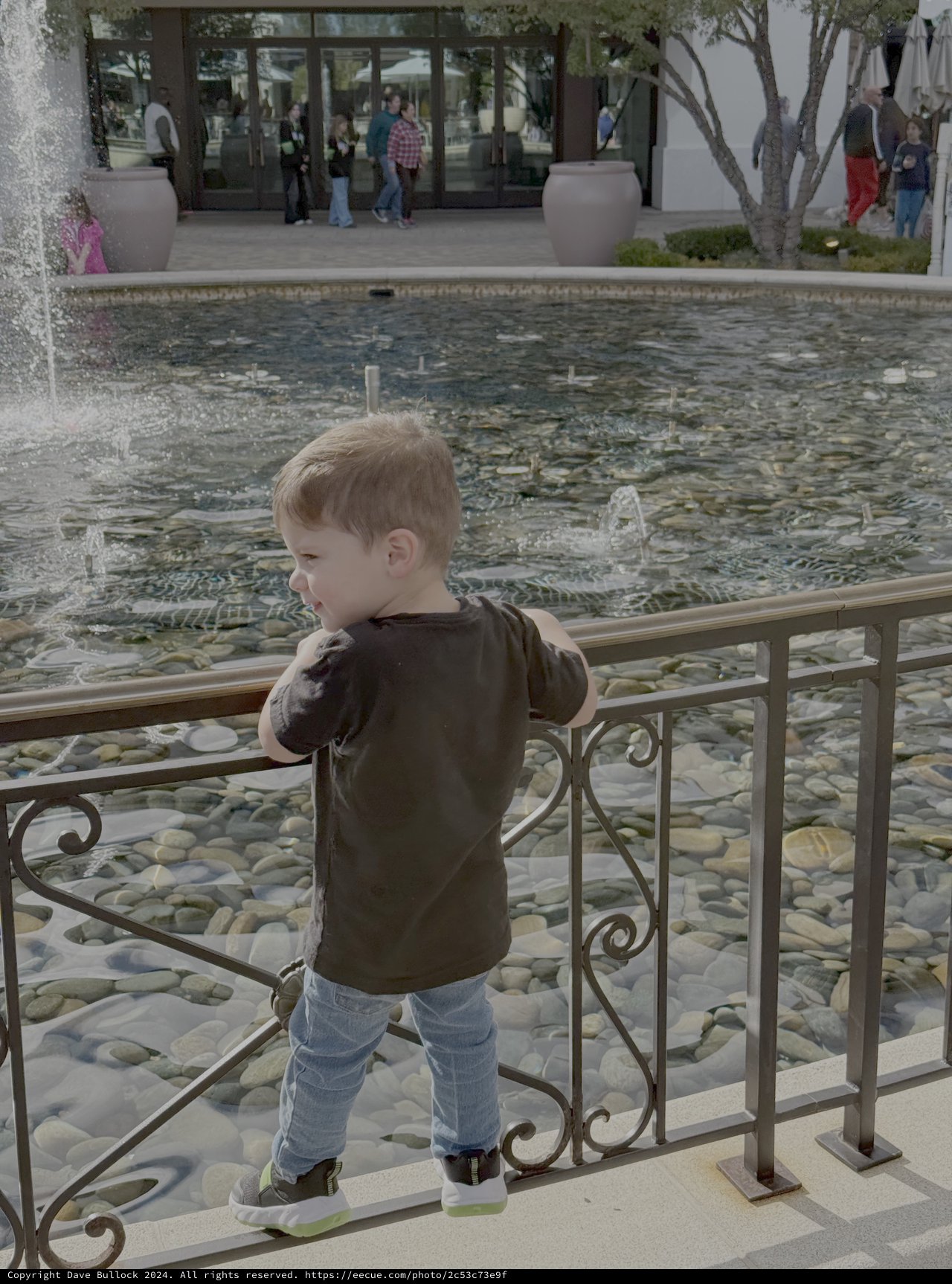 Toddler Watching Fountain at Modern Plaza