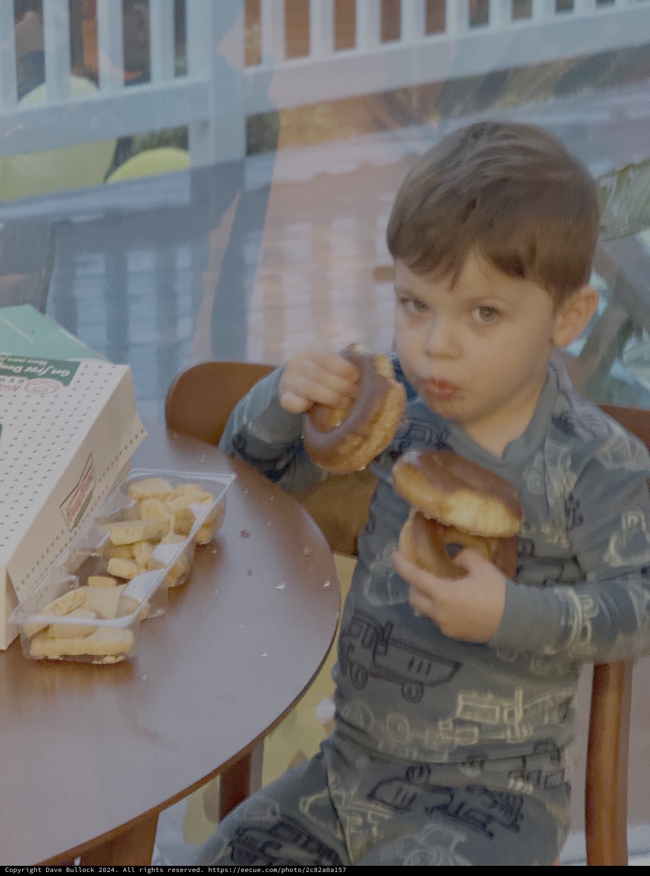 Young Child Enjoying Donuts at Home