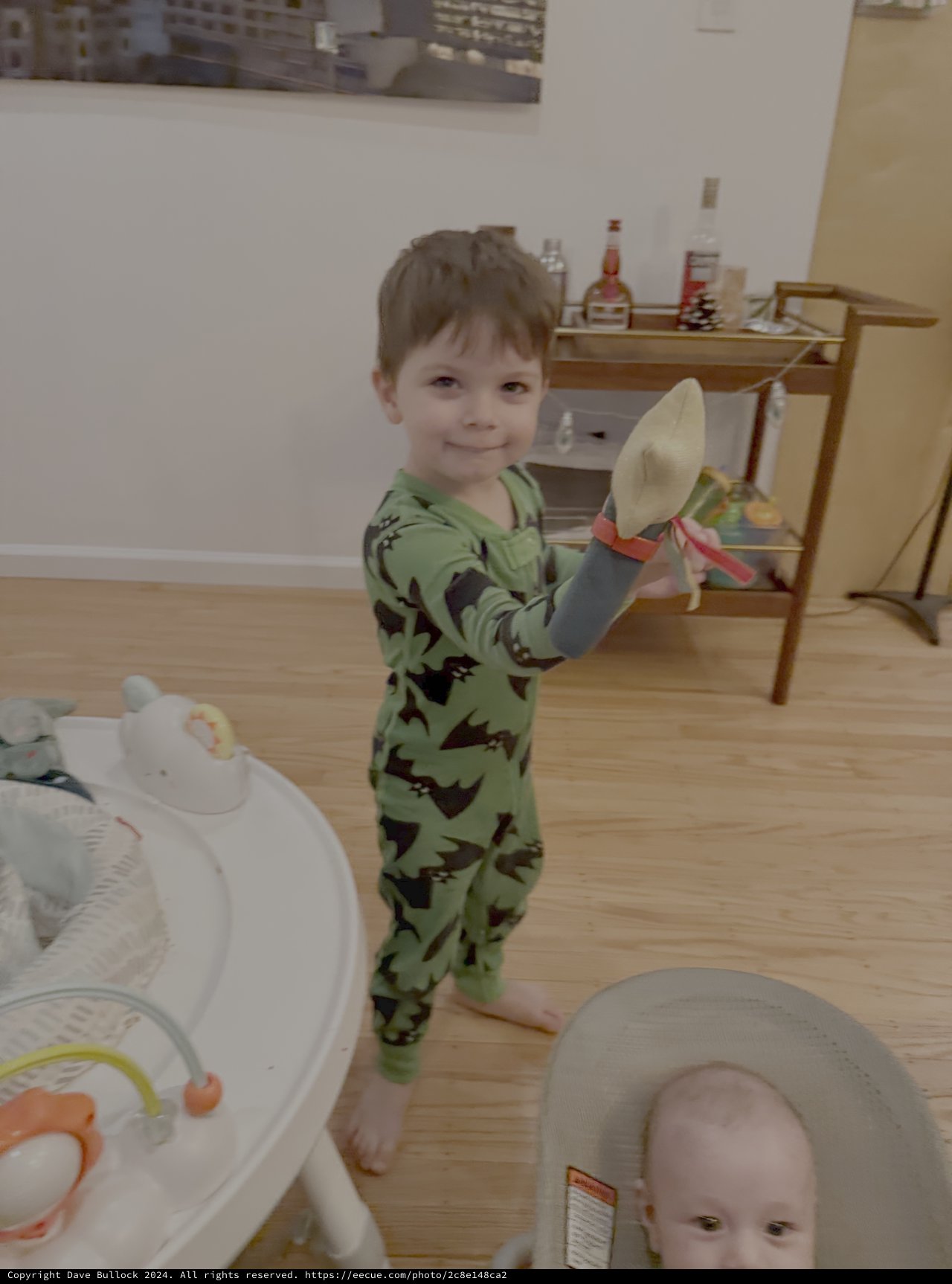 Toddler in Dinosaur Pajamas Playing with Kitchen Knife
