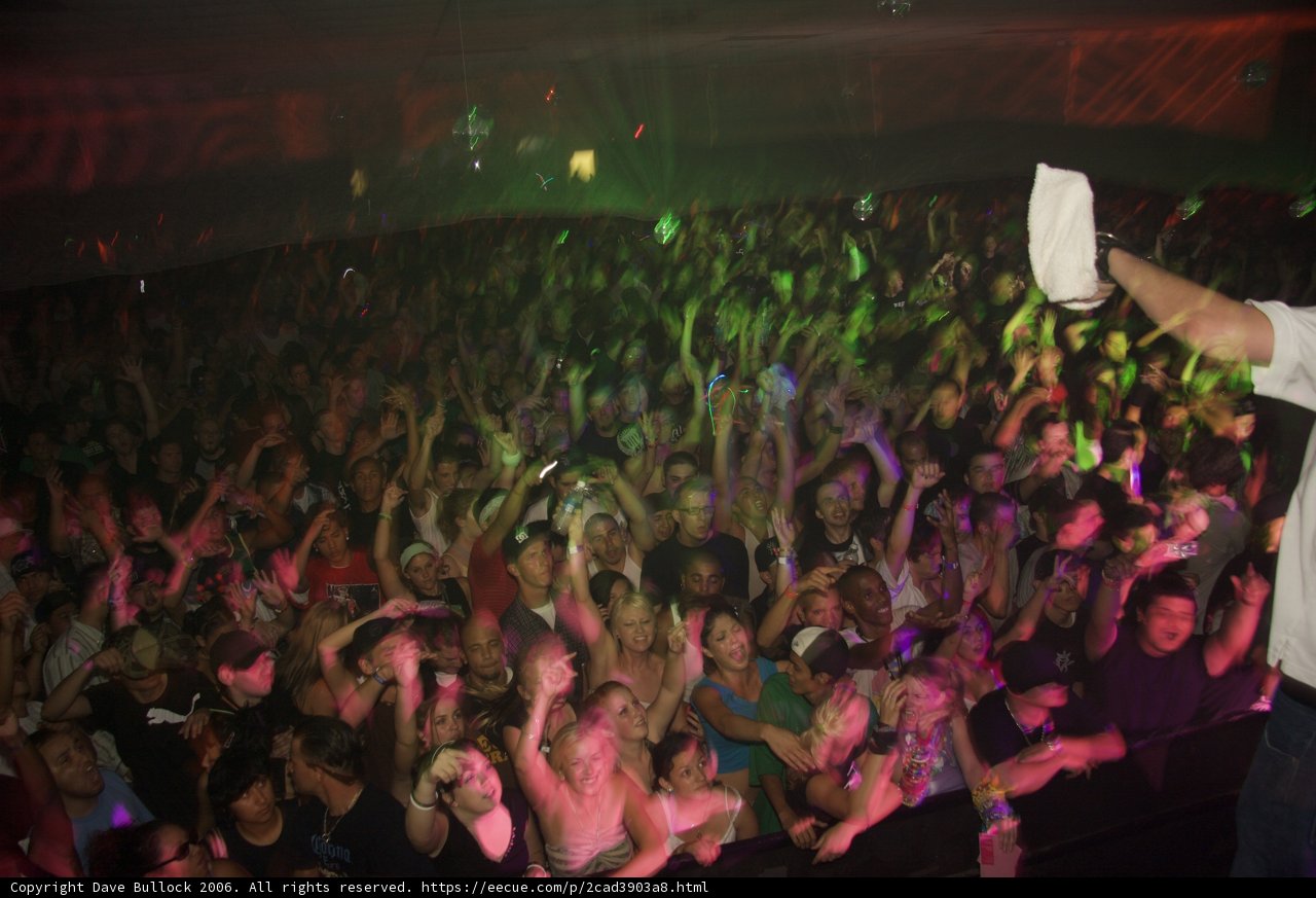 Man in White Shirt Commands Attention at Nightclub