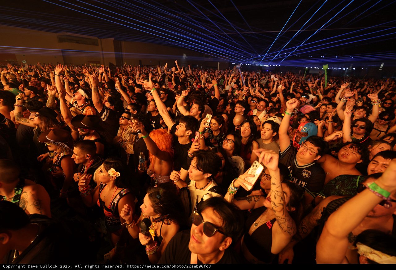 Massive Crowd Erupts Under Blue Laser Light Show