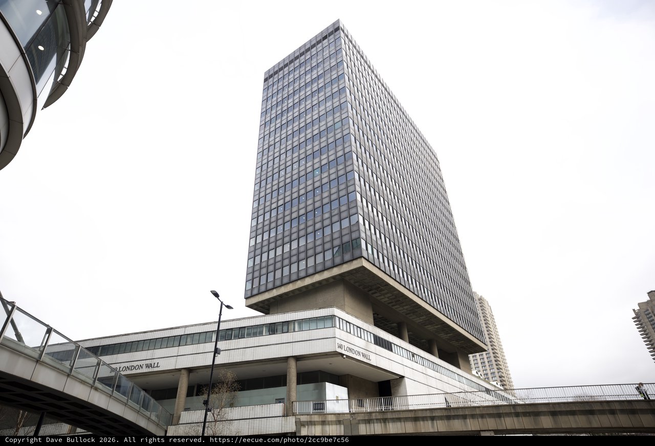 Brutalist Tower Rising Above London Wall Pedestrian Walkway