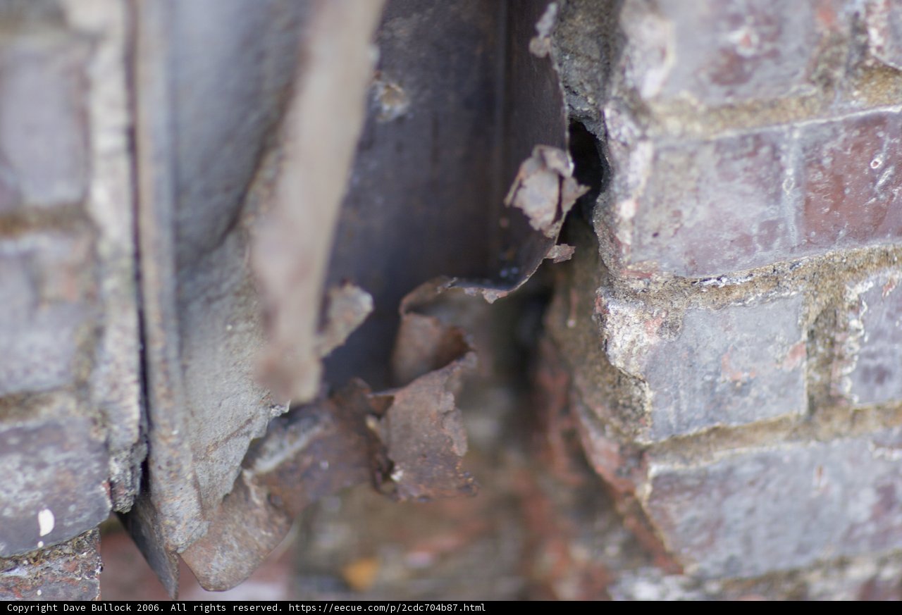 Rusty Metal Sticking Out of Brick Wall