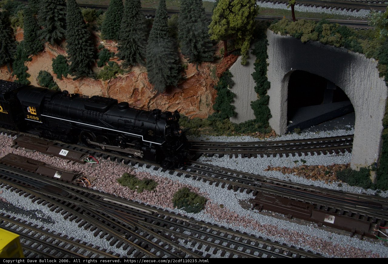 Miniature Train Chugging Through a Tunnel