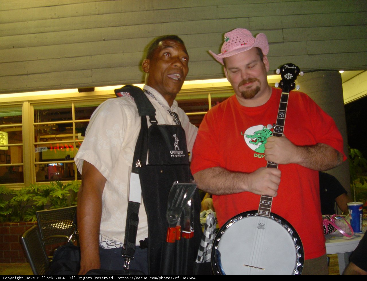 Red-Shirted Musician with Decorative Plant