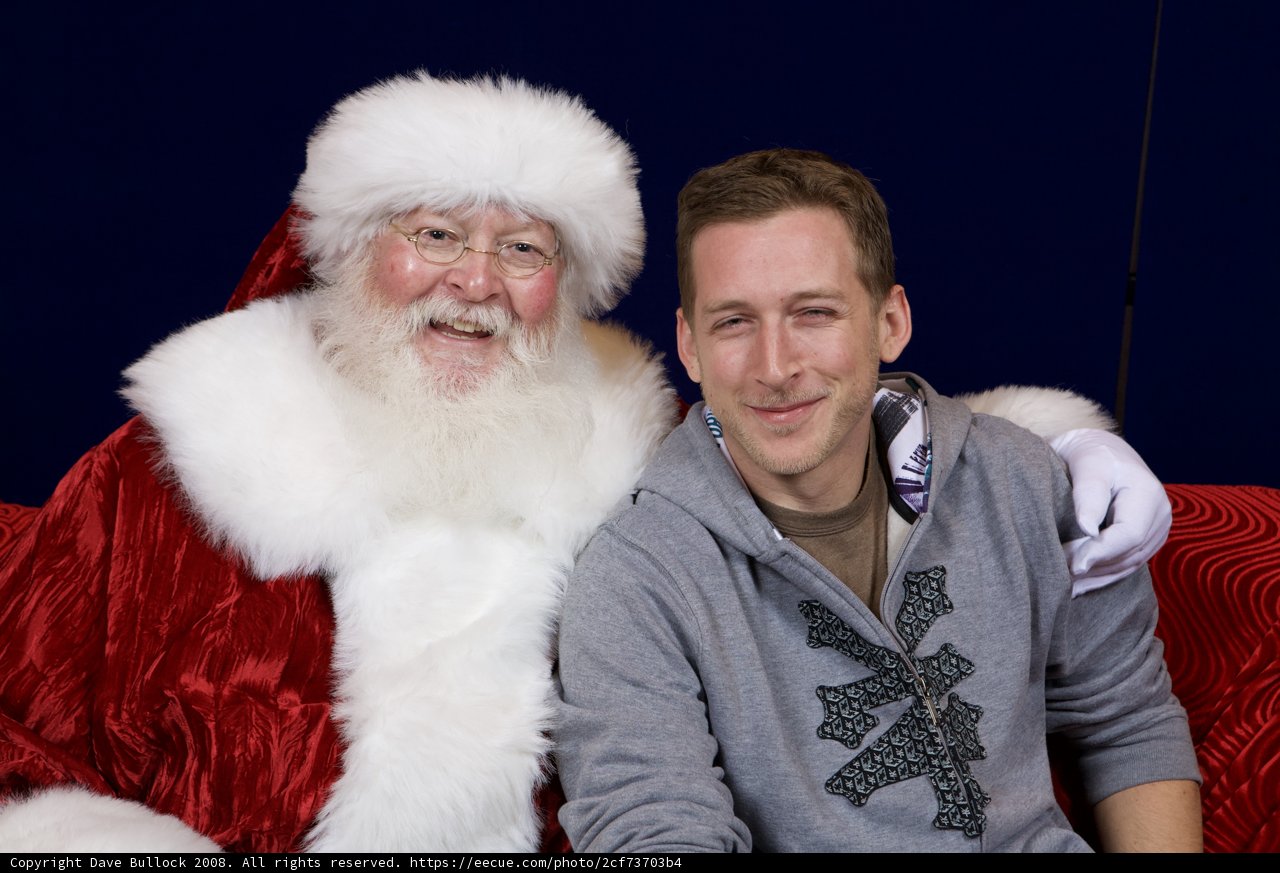 Cedrick O posing with Santa Claus at APC Christmas Party