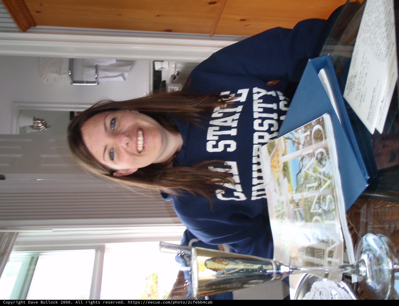 College Student Smiling with Cal State University Sweatshirt