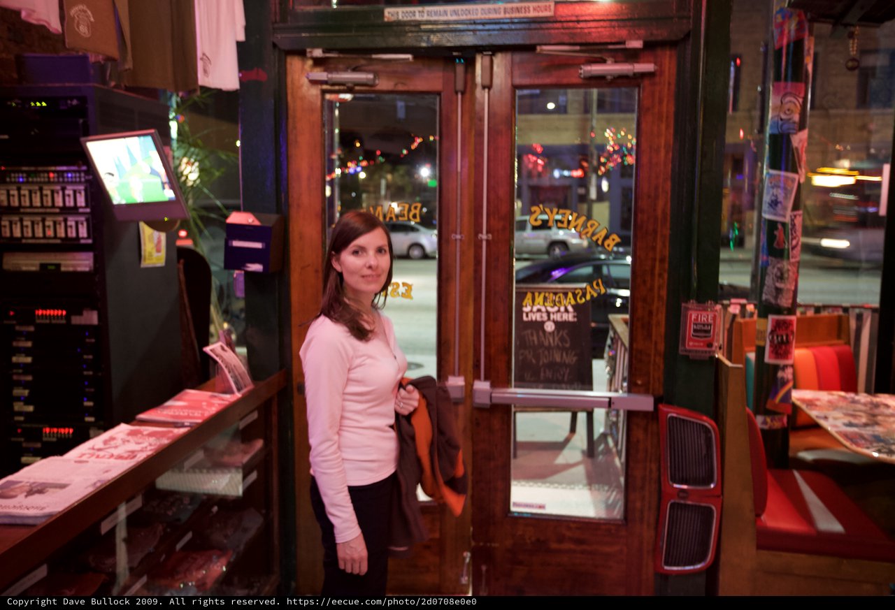 Woman at Entrance of Barney's Restaurant at Night